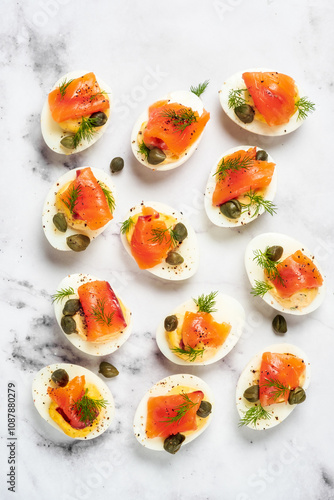 A plate of appetizers with salmon and capers