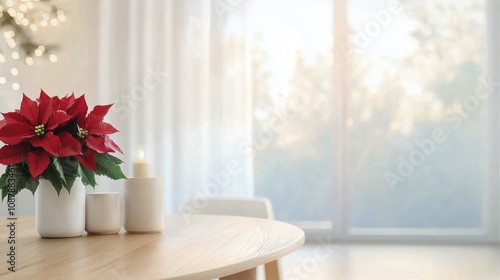 Cozy winter table setting with red poinsettia and white cup near a softly lit...