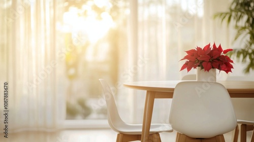 Cozy winter table setting with red poinsettia and white cup near a softly lit...