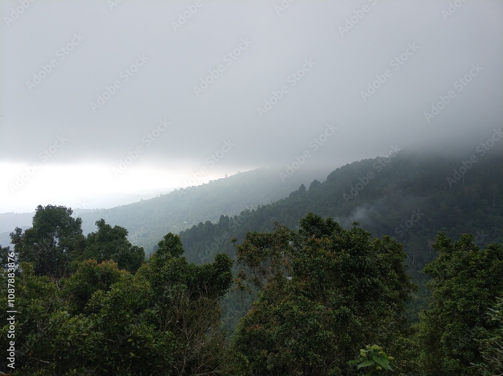Lush green tropical mountains with a rain cloud at the peak. Lush green tropical mountains with a rain cloud at the peak.