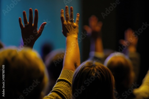 A group of people celebrating or showing approval by raising their hands up photo