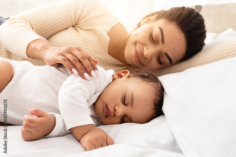 Loving Black Mom Hugging Sleeping Baby Lying In Bed In Bedroom At Home. Toddler Infant Sleeps Near Mom. Motherhood Lifestyle, Daytime Sleep Routine Concept. Selective Focus Loving Black Mom Hugging Sleeping Baby Lying In Bed In Bedroom At Home. Toddler Infant Sleeps Near Mom. Motherhood Lifestyle, Daytime Sleep Routine Concept. Selective Focus