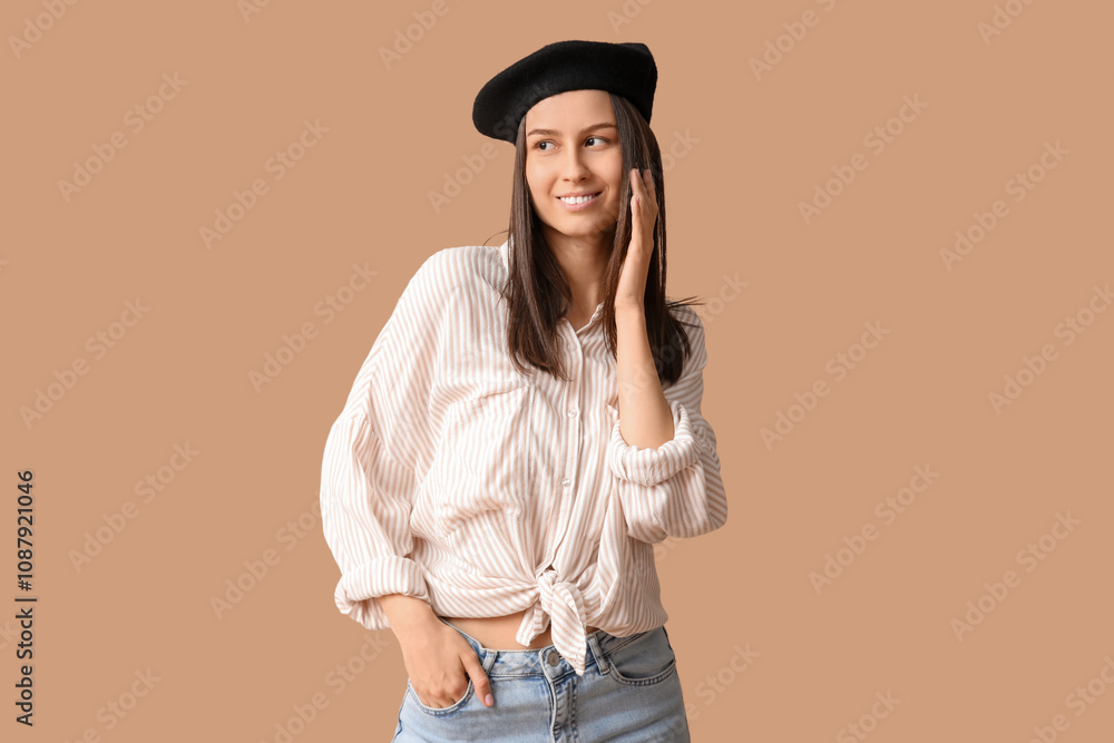 Beautiful young woman in stylish black beret hat on brown background Beautiful young woman in stylish black beret hat on brown background
