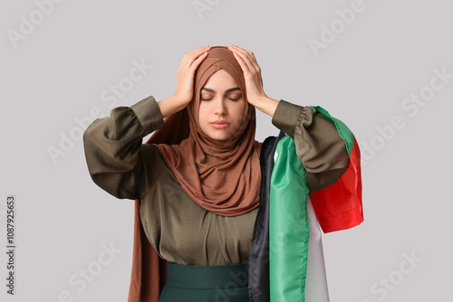 Young sad Muslim woman with...