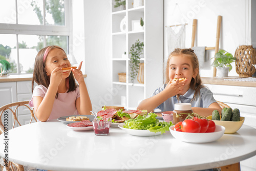 Cute little girls eating sw...
