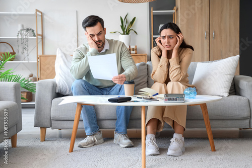 Worried young couple with b...