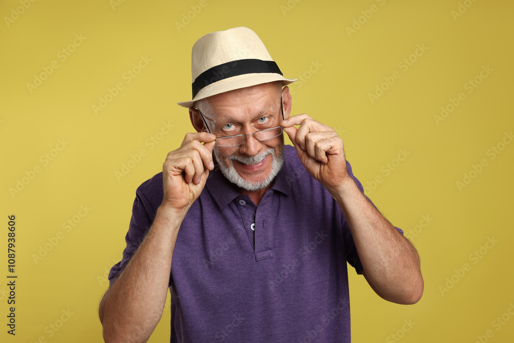 Portrait of handsome senior man on yellow background Portrait of handsome senior man on yellow background