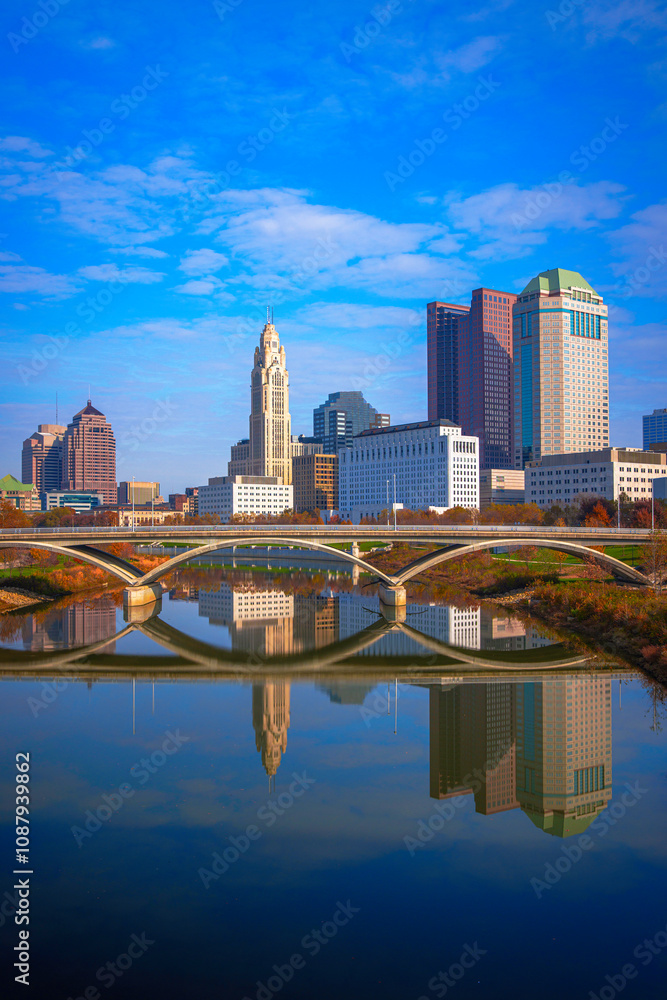 Fototapeta premium Columbus Ohio Skyline, Skyscrapers, and Landmark Buildings, USA: A vibrant tranquil beauty over the serene Scioto River water and green space in autumn