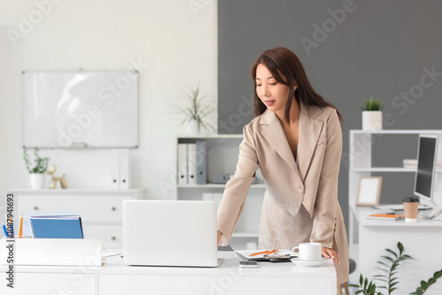 Asian businesswoman working...