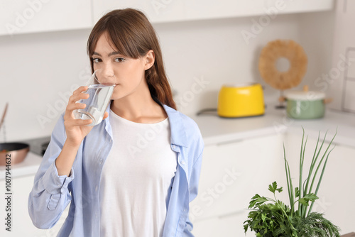 Young woman drinking water ...