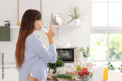 Young woman drinking water ...