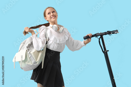 Cute schoolgirl with headph...