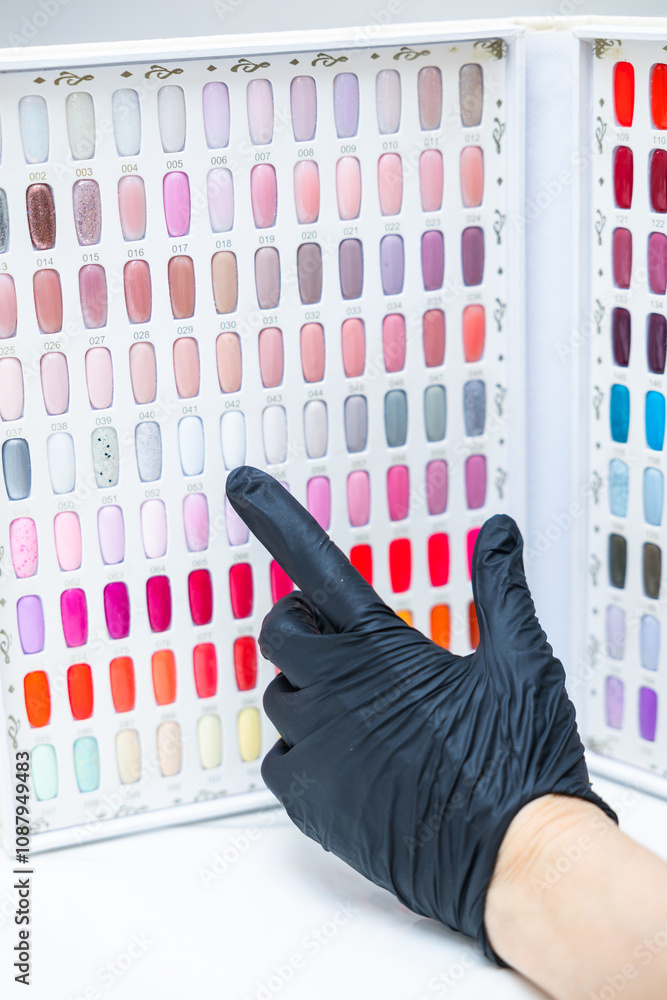 Φωτογραφία a palette of different nail colors for manicure and a hand pointing at them