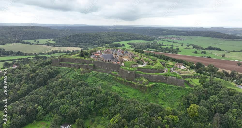Drone scenery of the Citadel of Montmedy on a hill surrounded by greenery in Montmedy-Haut, France Drone scenery of the Citadel of Montmedy on a hill surrounded by greenery in Montmedy-Haut, France