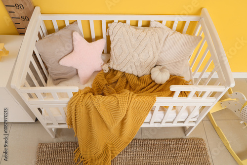 White wooden baby crib with...