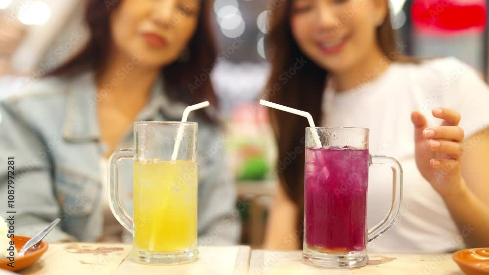 Family relationship, mother's day concept. Happy Asian mother and daughter enjoy outdoor lifestyle shopping and having lunch eating food together in restaurant at shopping mall on holiday vacation. Family relationship, mother's day concept. Happy Asian mother and daughter enjoy outdoor lifestyle shopping and having lunch eating food together in restaurant at shopping mall on holiday vacation.