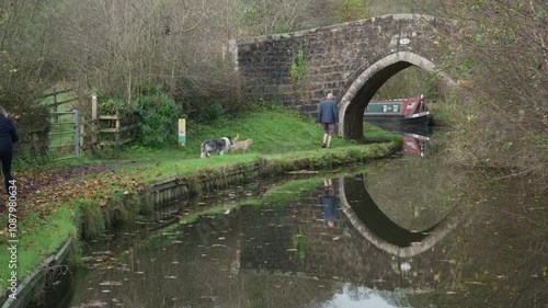 FROGHALL, STAFFORDSHIRE, ENGLAND - NOVEMBER 11 2024: Dog walkers along the Caldon canal near Froghall.