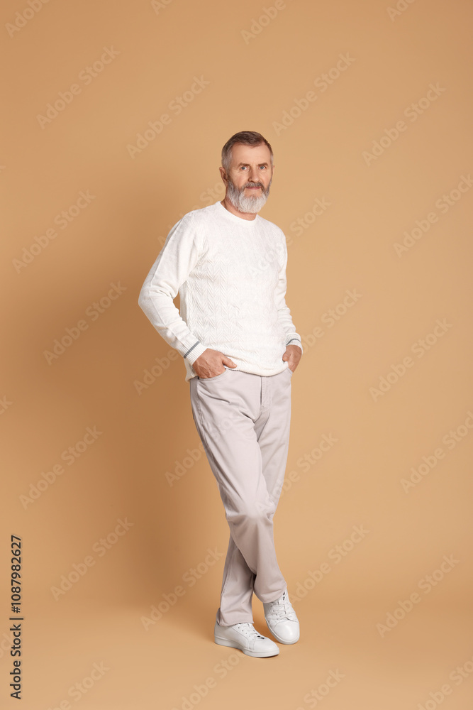 Portrait of senior man on beige background Portrait of senior man on beige background