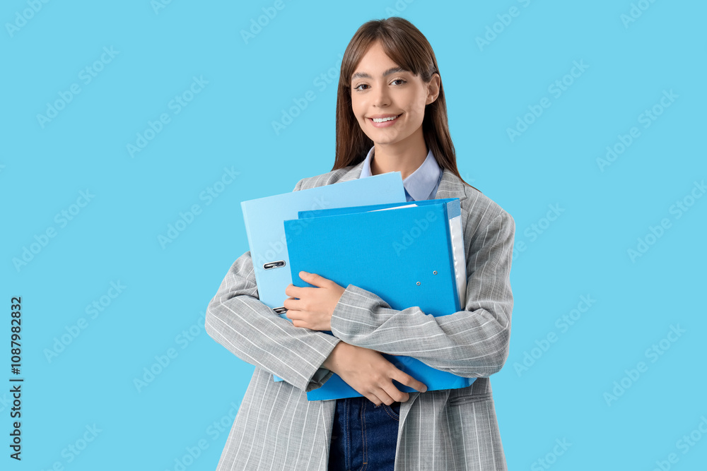 Young businesswoman with folders on blue background Young businesswoman with folders on blue background