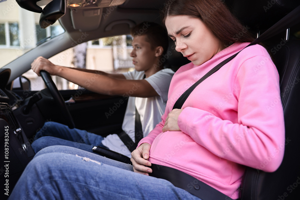 Pregnant woman travelling with her husband by car Pregnant woman travelling with her husband by car