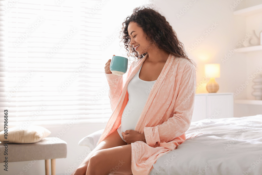 Portrait of beautiful pregnant with cup of drink on bed at home Portrait of beautiful pregnant with cup of drink on bed at home