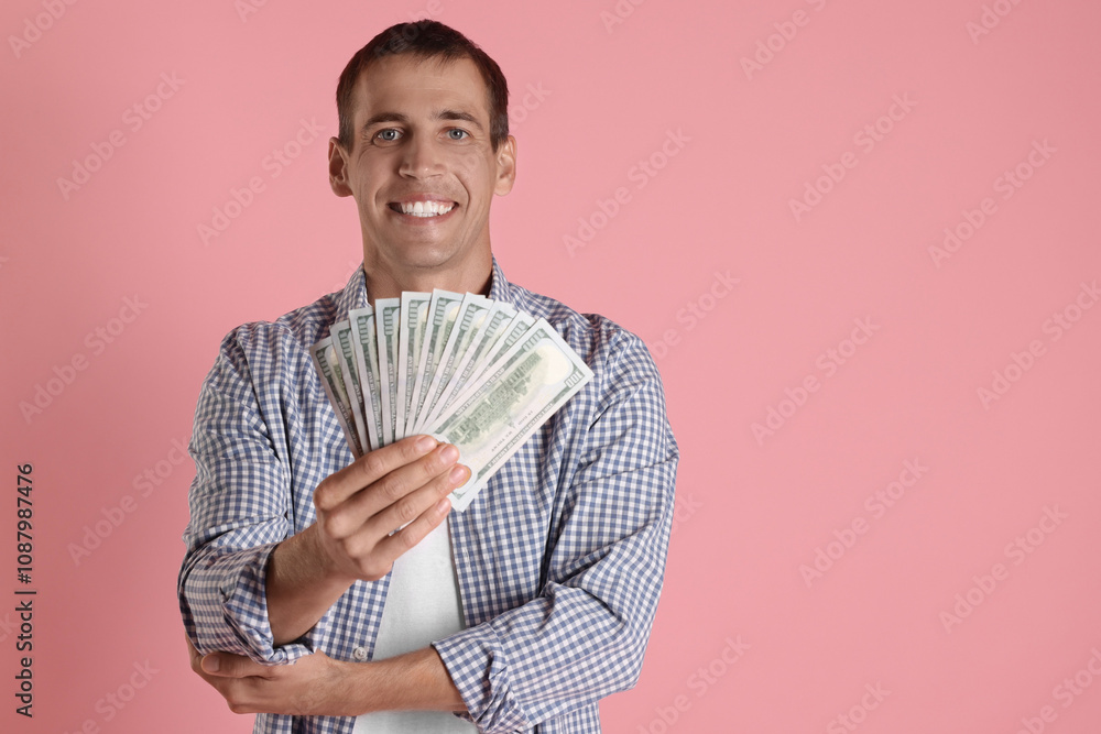 Happy man with money on pink background, space for text Happy man with money on pink background, space for text