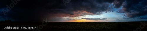 Summer sunset over wheat field. Beautiful sunset sky over countryside