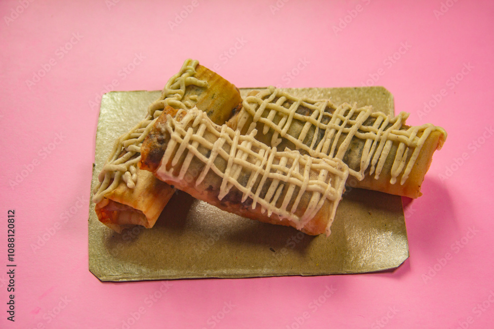 Crispy banana cake, sweet banana cake with sweet topping on a Pink background Crispy banana cake, sweet banana cake with sweet topping on a Pink background