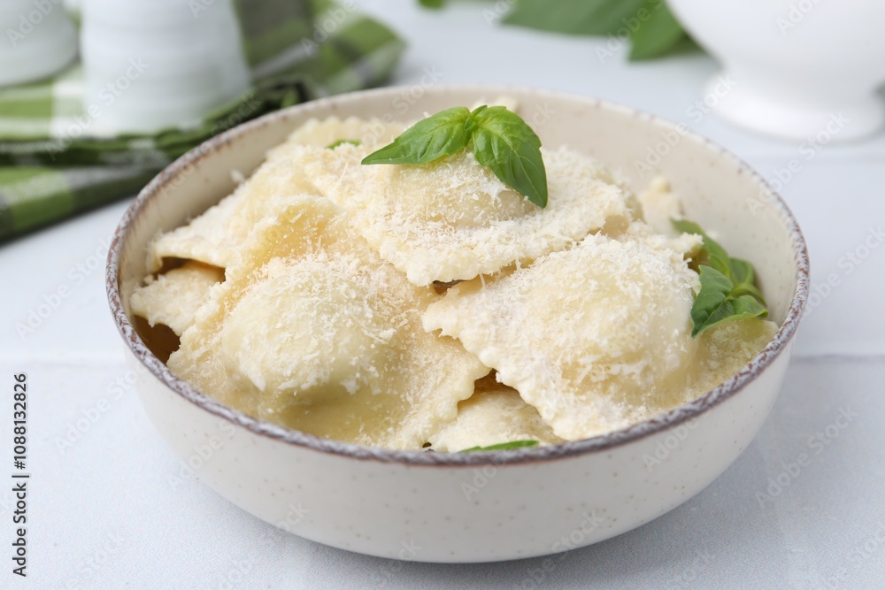 Delicious ravioli with cheese and basil on white tiled table, closeup Delicious ravioli with cheese and basil on white tiled table, closeup