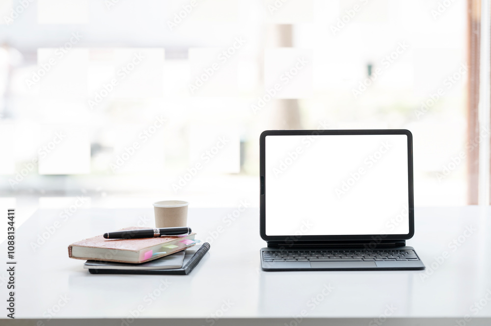 Digital tablet blank screen on the desk with coffee and book pencils at the office. Digital tablet blank screen on the desk with coffee and book pencils at the office.