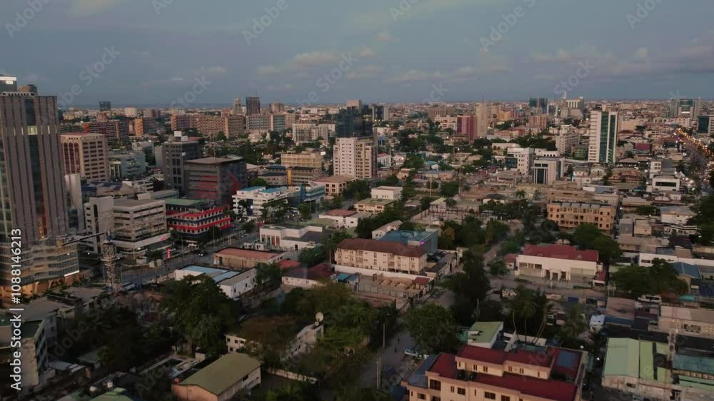 Aerial drone shot of cityscape in Kenya, buildings and roads visible below, with cloudy sky overhead, showcasing the urban landscape and natural surroundings. Aerial drone shot of cityscape in Kenya, buildings and roads visible below, with cloudy sky overhead, showcasing the urban landscape and natural surroundings.