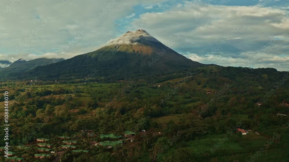 Aerial drone shot of the Arenal Volcano in Costa Rica. High view of the tropical rainforest. Lush landscape home to biodiversity and thermal springs. Aerial drone shot of the Arenal Volcano in Costa Rica. High view of the tropical rainforest. Lush landscape home to biodiversity and thermal springs.