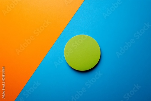 Minimalist green circle centered on vibrant blue and orange split background showcasing modern art design photo