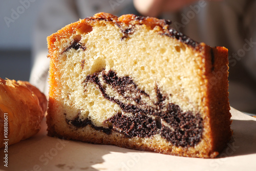 Enjoy a Delicious Slice of Marble Cake Topped with Irresistible Chocolate Swirls