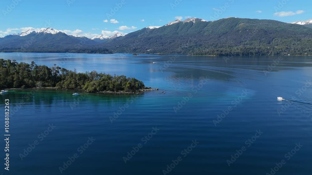 aerial view of Lynch Bay in the Arrayanes Forest, located within Nahuel Huapi Lake in Patagonia, Argentina. The pristine blue waters contrast with the lush green forest. aerial view of Lynch Bay in the Arrayanes Forest, located within Nahuel Huapi Lake in Patagonia, Argentina. The pristine blue waters contrast with the lush green forest.