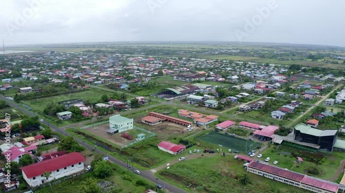 Aerial: Drone view over new Nickerie, Suriname, small city, drone ascending photo