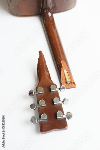 part of broken wood acoustic guitar isolated on white background