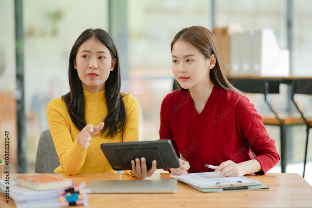 Asian business woman working and talking in the office Asian business woman working and talking in the office