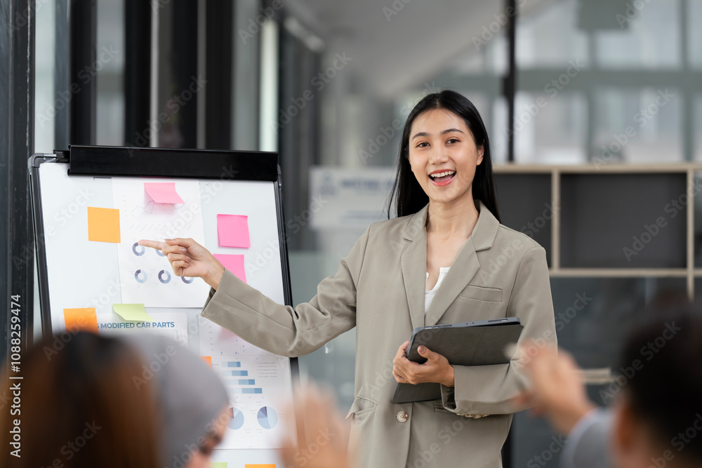 Confident business woman standing in front of her company, presenting her project and ideas on a board. Confident business woman standing in front of her company, presenting her project and ideas on a board.