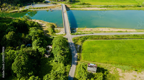 Panoramic aerial drone view of green paddy crops with waterway canal at Kampung Wai, Perlis, Malaysia photo