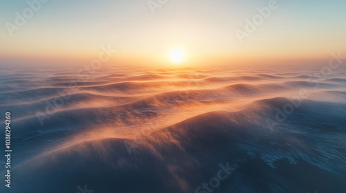 Drone shot capturing sand dunes enveloped in thick fog as the sunrise paints the sky in warm hues creating a surreal serene and mystical landscape with golden light filtering through the mist