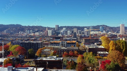  aerial view of downtown Portland, Oregon, showcasing its iconic skyline and vibrant neighborhoods adorned with fall foliage.