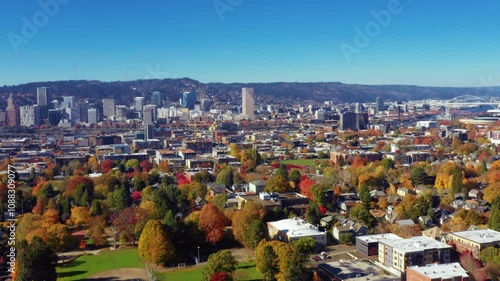  aerial view of downtown Portland, Oregon, showcasing its iconic skyline and vibrant neighborhoods adorned with fall foliage.