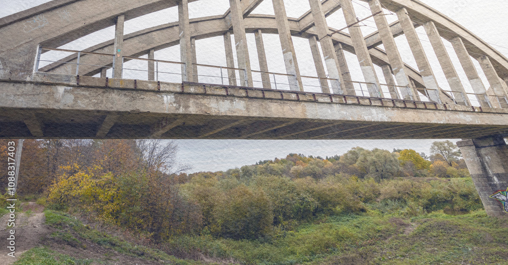Bridge spans a river with a green field on the other side