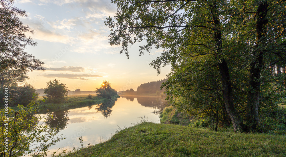 Beautiful sunset over a river with trees in the background Beautiful sunset over a river with trees in the background