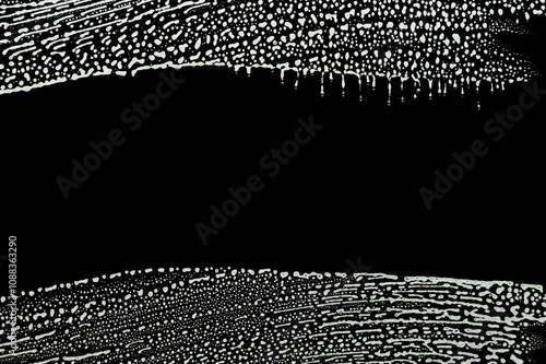 soap foam wipe marks on window glass, black background