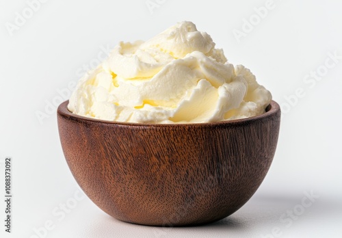 Creamy whipped cream in a wooden bowl photo