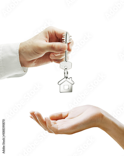 A hand holding a key with a house-shaped keychain passing it to an open palm, isolated on a white background. Concept of home purchase or real estate photo