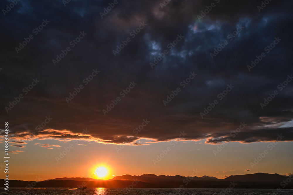 Sunrise over the sea and mountains. Beautiful colorful sunrise at the sea with dramatic clouds and sun shining. Sunrise over the sea and mountains. Beautiful colorful sunrise at the sea with dramatic clouds and sun shining.