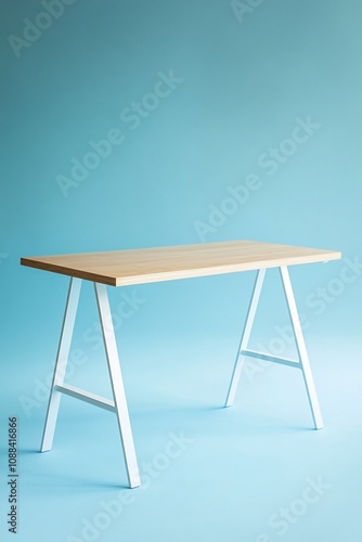 Minimalist Desk with Light Wood Top and White Metal Legs on Plain Blue Background